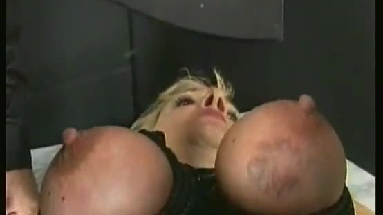 Blond slave with big tits is spanked and got her boobs tied together with a rope by master
